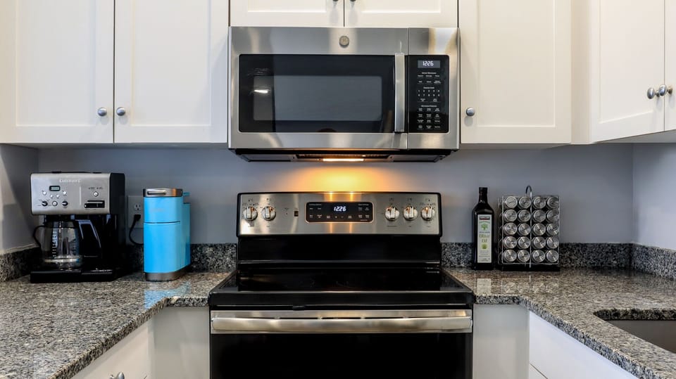 Cuisinart drip coffee, K-cup coffee maker, & a wide variety spice rack provided