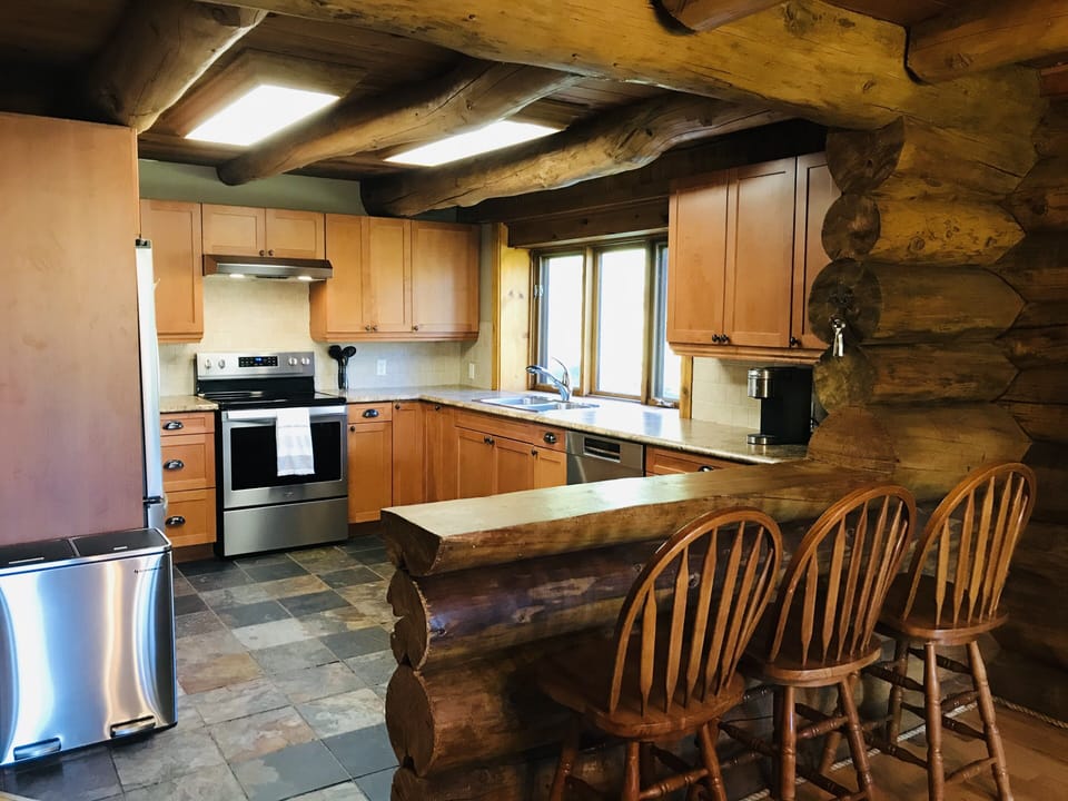 Peninsula and bar stools between kitchen and dining room. 