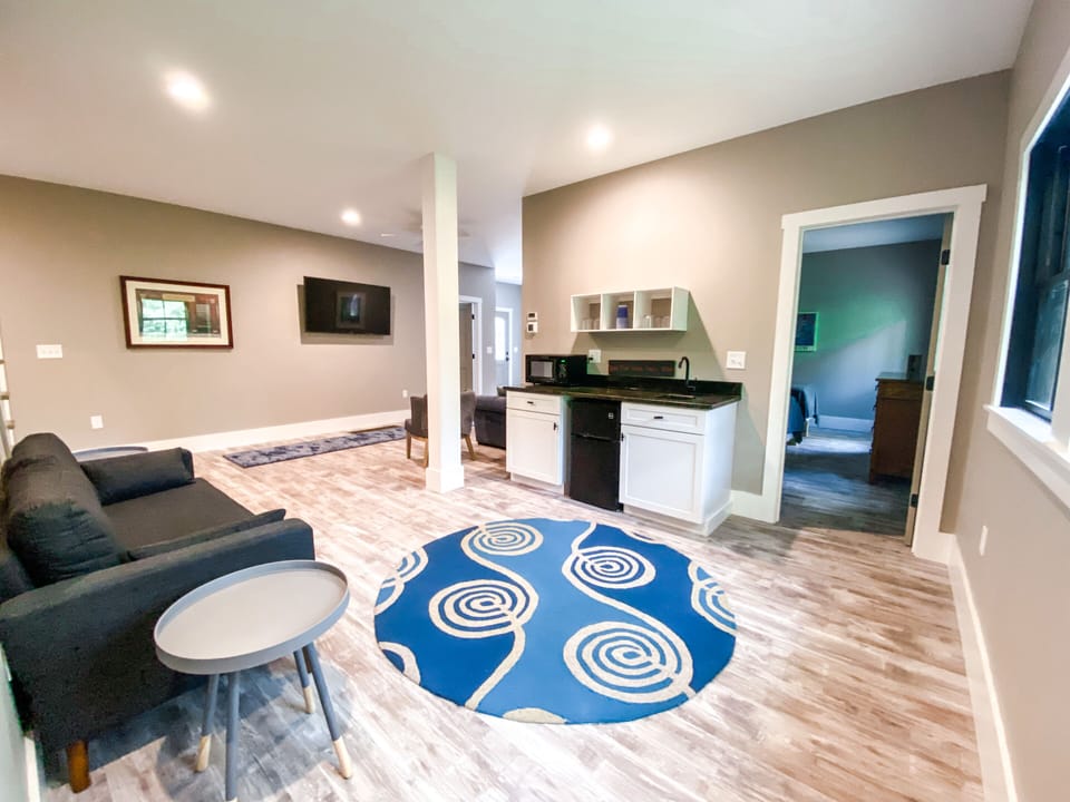 The downstairs den includes a tv, 2 couches, a wet bar, mini fridge & microwave.