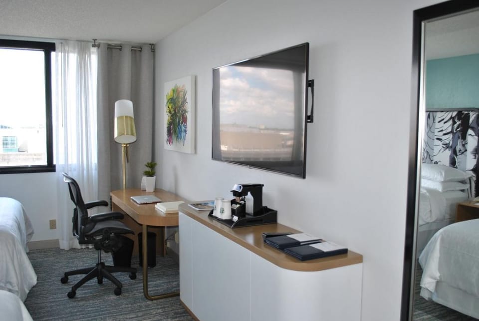 Settle in with a spacious desk, TV, and refreshments.