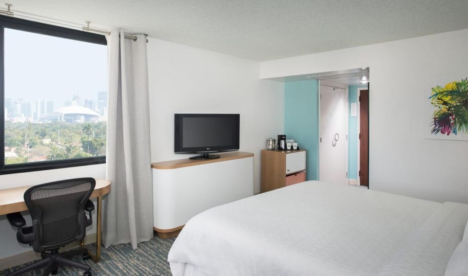 Unwind in a bright room with skyline views and comfort.