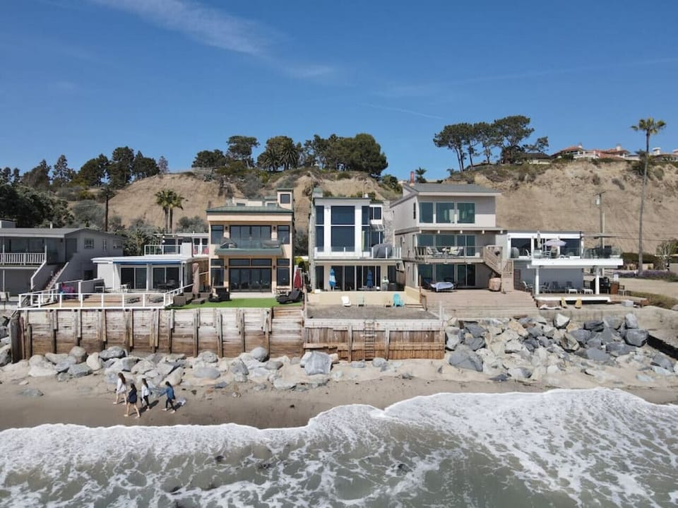 Beachfront exterior set right on the sand w/ private patios facing the water