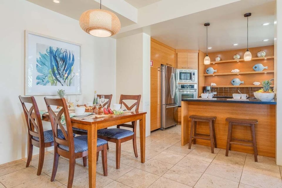 Share meals at a beautifully set dining table framed by vibrant artwork.