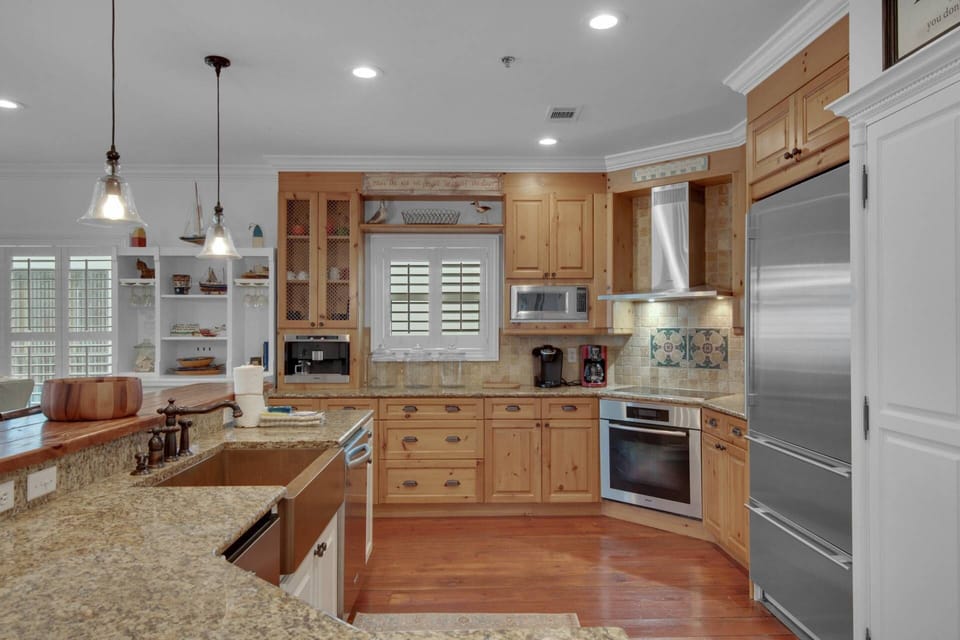 The well-appointed kitchen features granite countertops and stainless steel appliances