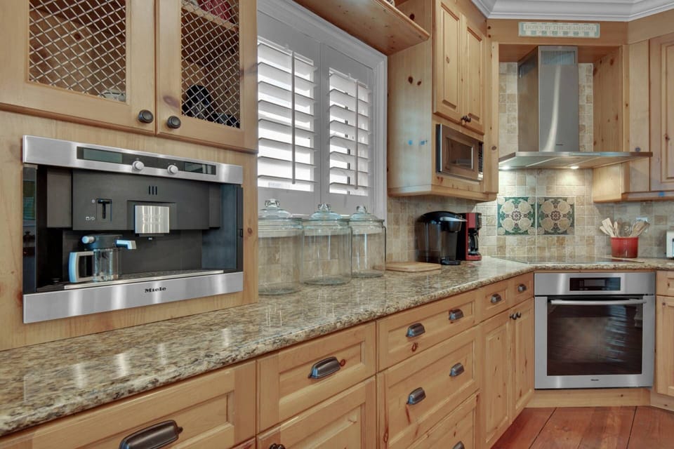 The well-appointed kitchen features granite countertops and stainless steel appliances
