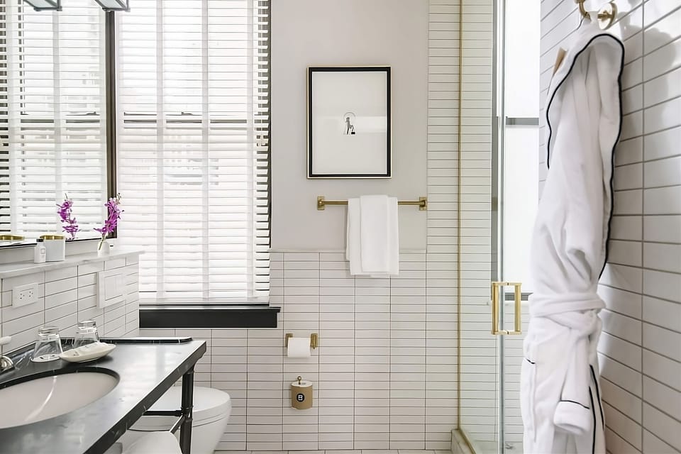Indulge in a spa-bright bath with plush robe ready.
