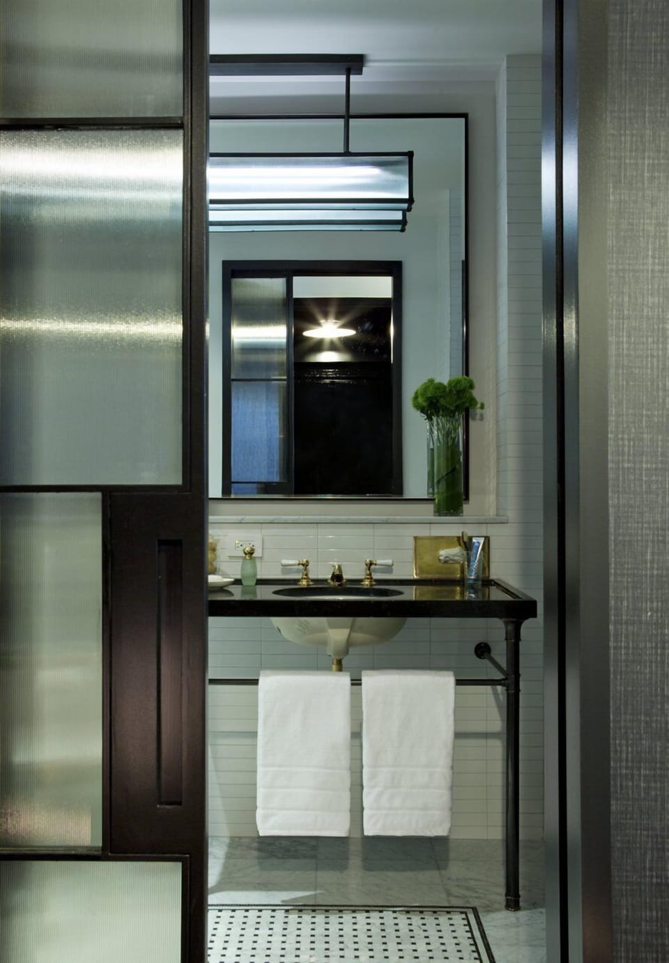 Step into a modern bath with polished fixtures and calm lighting.