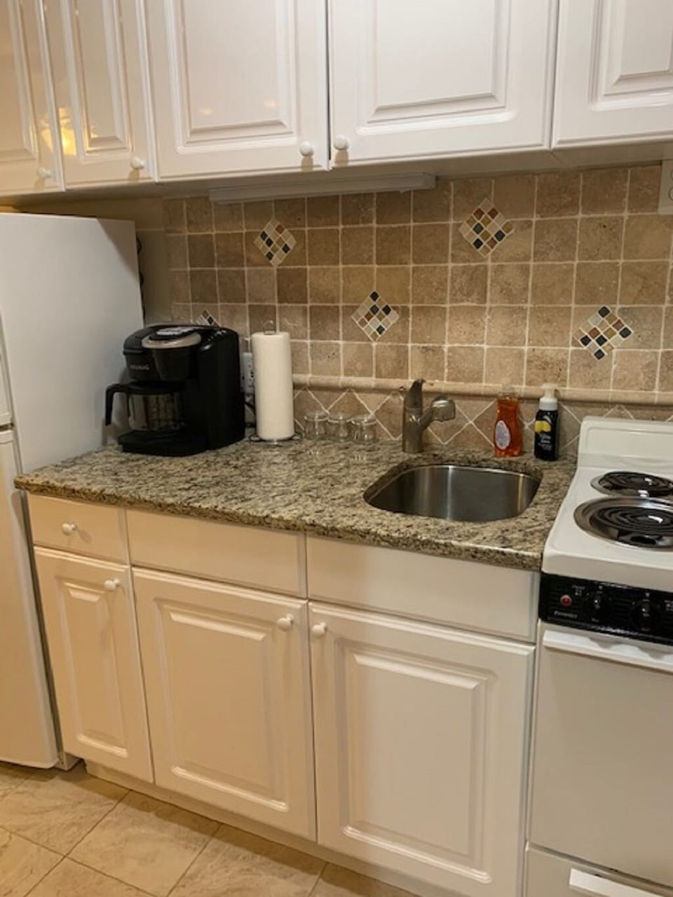 fully equipped kitchen with plates, cups, mugs, utensils, cooking pots, etc
