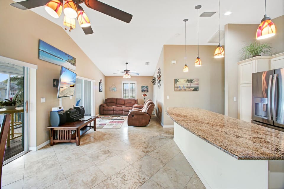 Open-concept living, dining and kitchen area is ideal for families. Large smart TV in living area with live TV and accessible for streaming services.