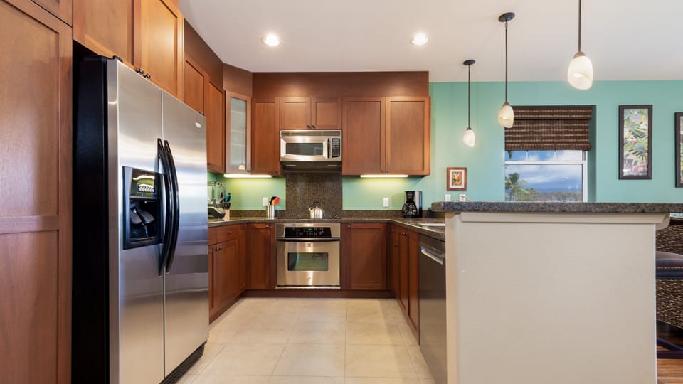 Gourmet kitchen fully stocked with spices, oil and cookware essentials