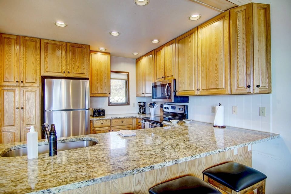 Full kitchen with stainless steel appliances and plenty of space.