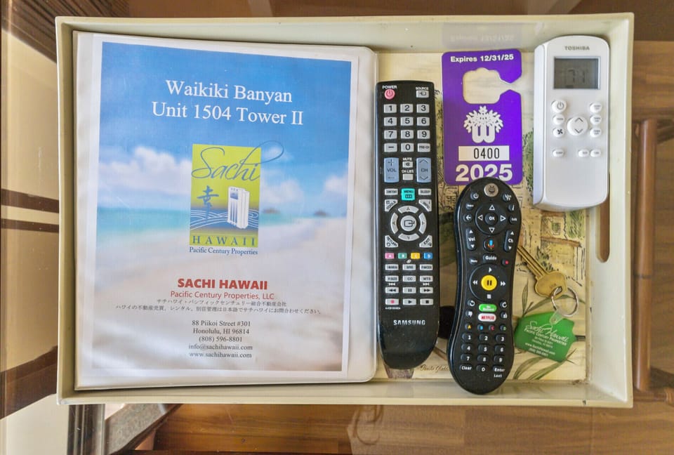Living Room - Sachi Hawaii unit manual provides important information on amenities, internet password, how to operate the TV, parking pass (free parking!), A/C control unit and unit keys!