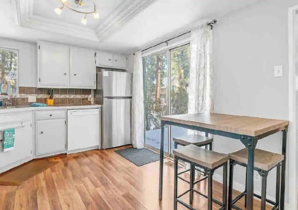kitchen has sliding glass door out to front wooden deck.  leads to driveway