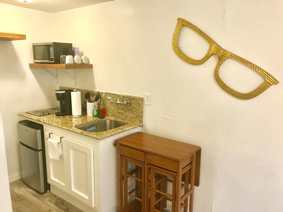 Kitchenette is equipped with Keurig, microwave, 2 burner stove top, basic cooking needs and large sink. A two person folding table is perfect for working or dining. 