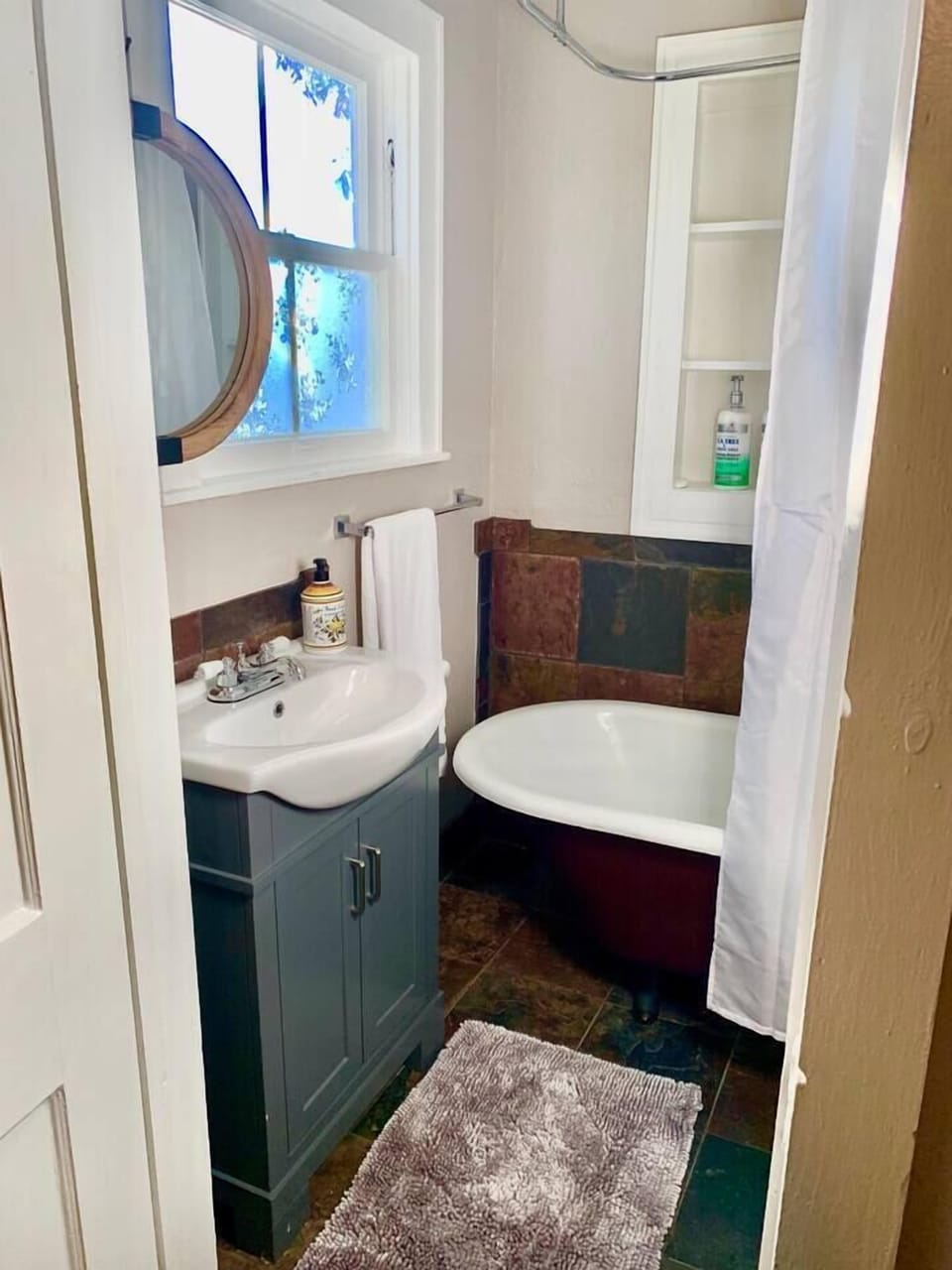 Clawfoot tub bathroom - hair dryer provided