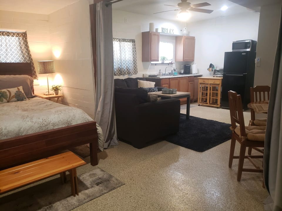 View from bedroom area into kitchen living area. Lots of natural light.