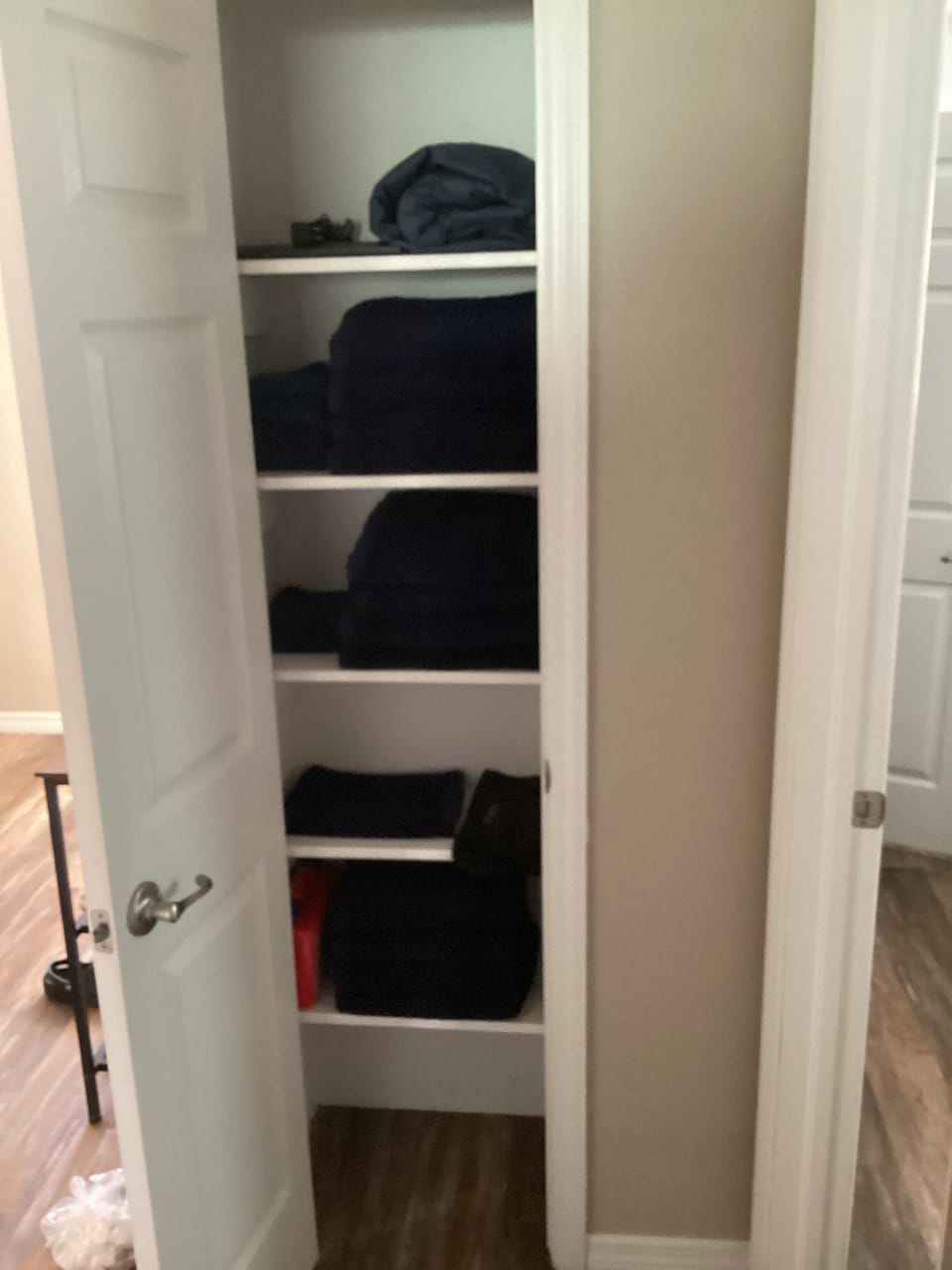 Linen closet with provided linens located in hallway outside bedrooms and bath.