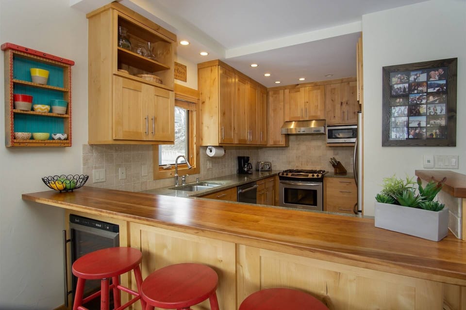 Open kitchen fully stocked with essentials and a bar area—great for cooking, eating, and entertaining.