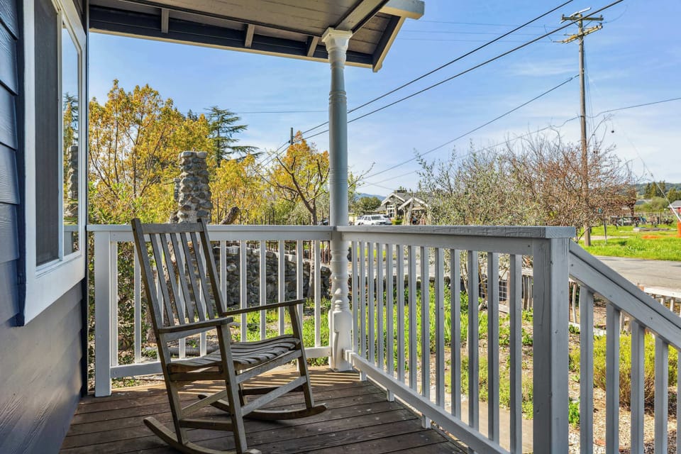 Relax on the cozy front porch with a rocking chair and peaceful neighborhood views—perfect for morning coffee or unwinding at sunset.
