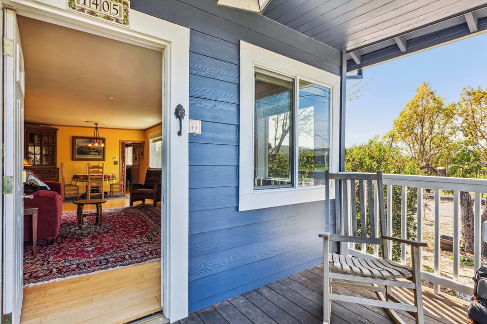 Inviting front porch leading into a warm, cozy living space—perfect for relaxing outdoors or stepping into the home's charming interior.
