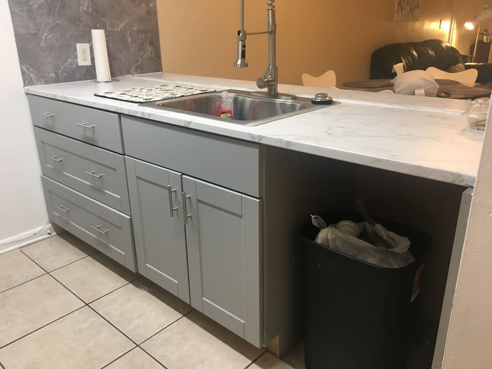 New kitchen with garbage disposal and modern counters and pull down spray faucet