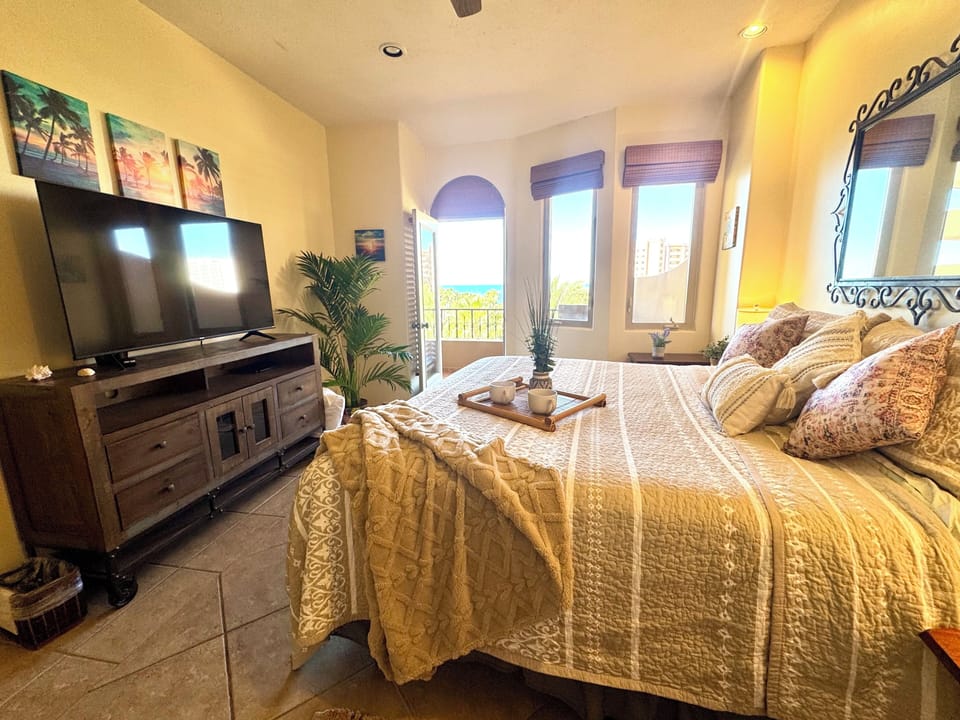 King Master Suite, premium bedding, sea views, balcony access, 55” TV