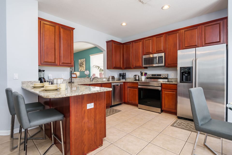Kitchen with stainless appliances & granite worktops 