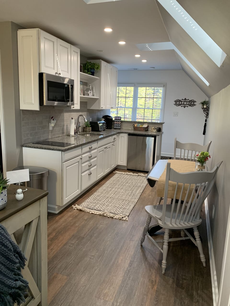 Kitchen has small table with 2 leaves that can be raised for additional seating.