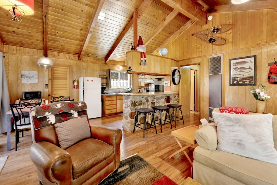Cozy lounge with comfortable sofas, rustic touches, and glowing natural light, blending charm and relaxation for guests seeking a peaceful retreat.