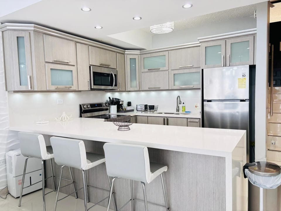 Remodeled kitchen. Ideally selected furniture and appliances, soft bar stools.