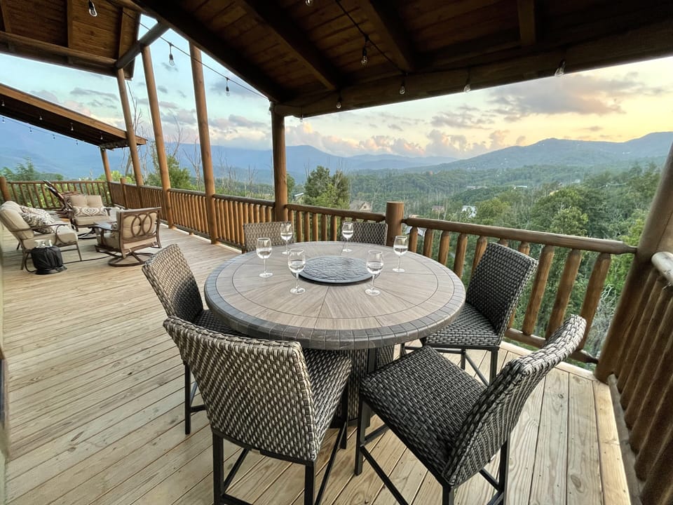 HUGE main level deck w/ lounge area, fire pit, rockers, and FIRE dining table 