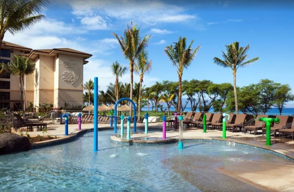 Kids pool has fun water features. And there's plenty of room to lounge poolside.