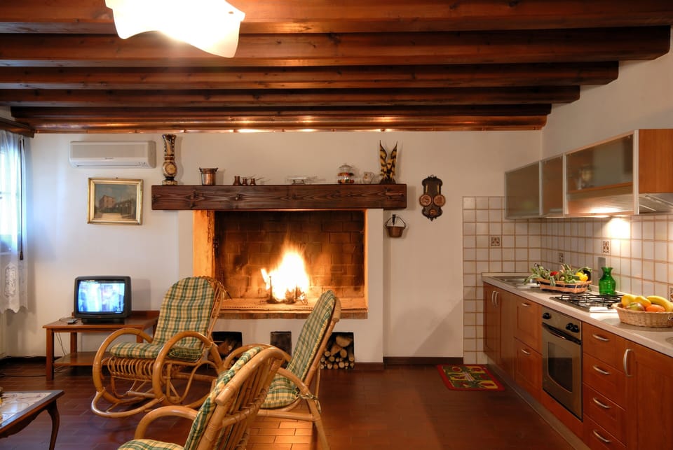Living room with fireplace and kitchenette