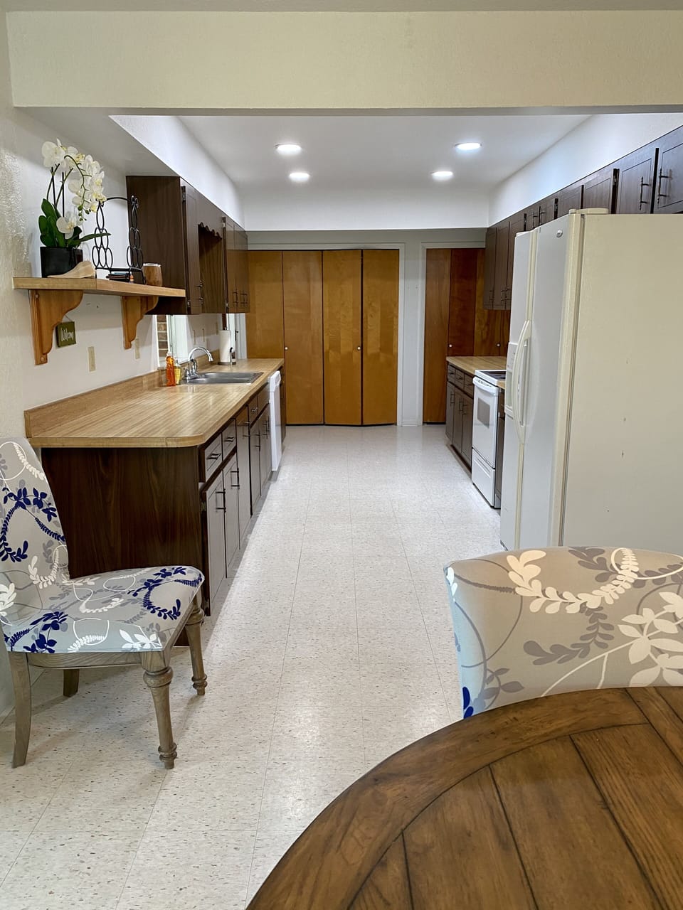 The galley kitchen with a widow to the sunroom. 
