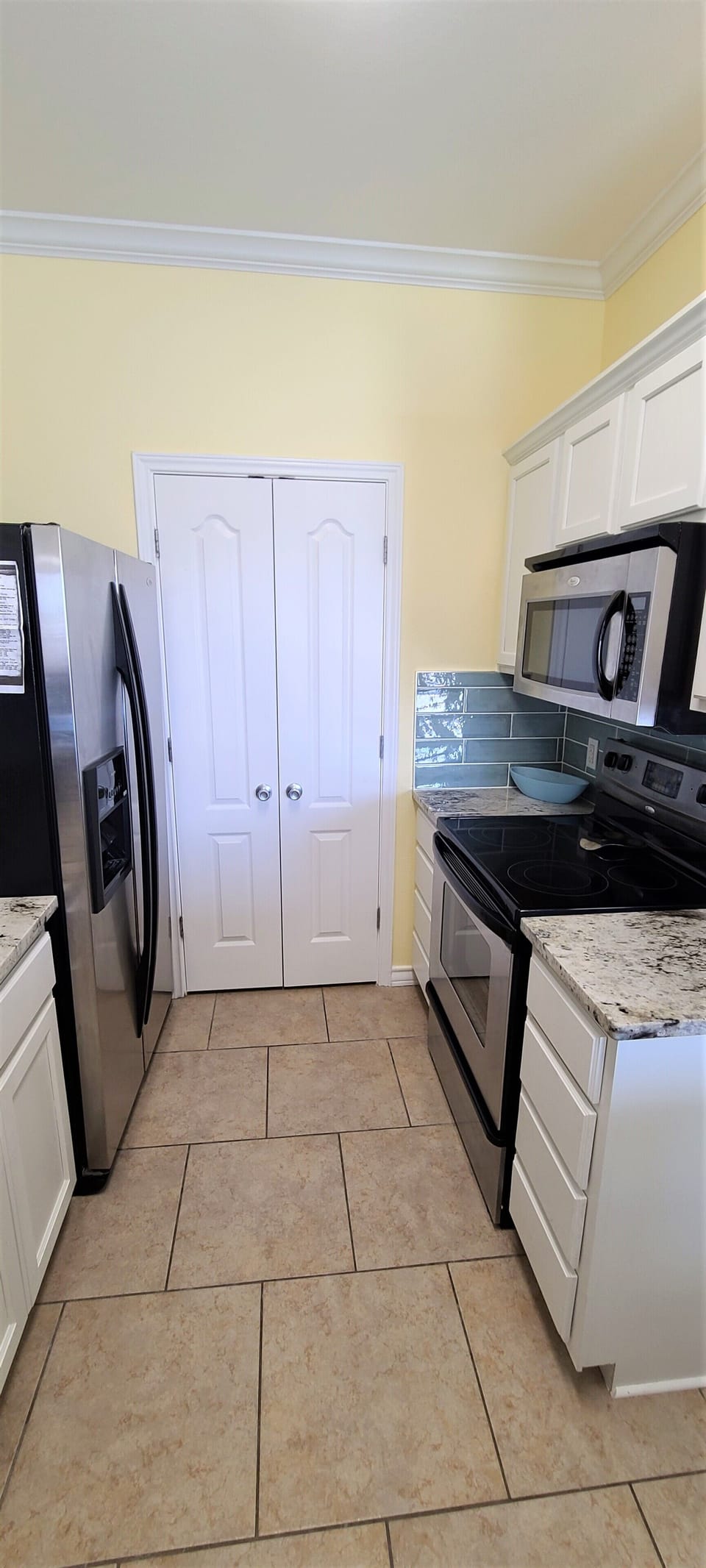 Kitchen - fridge, electric stove/range, microwave, laundry room