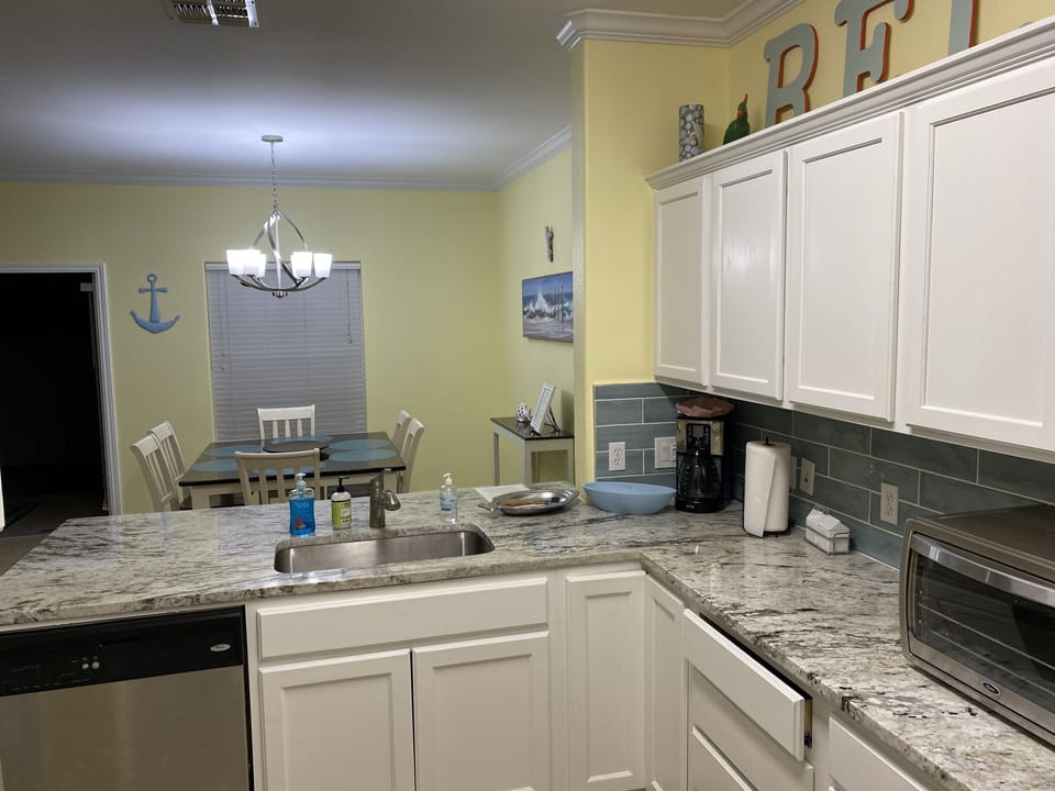 Kitchen - stocked with pots/pans, plates/glasses, cooking utensils, flatware