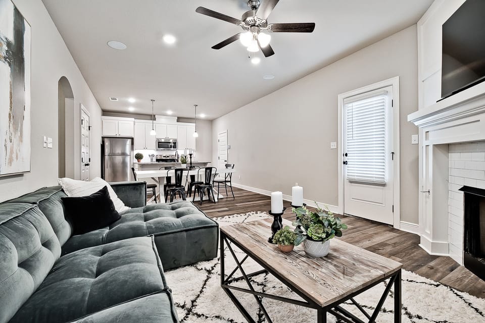 Open living/dining/kitchen area with access to driveway.