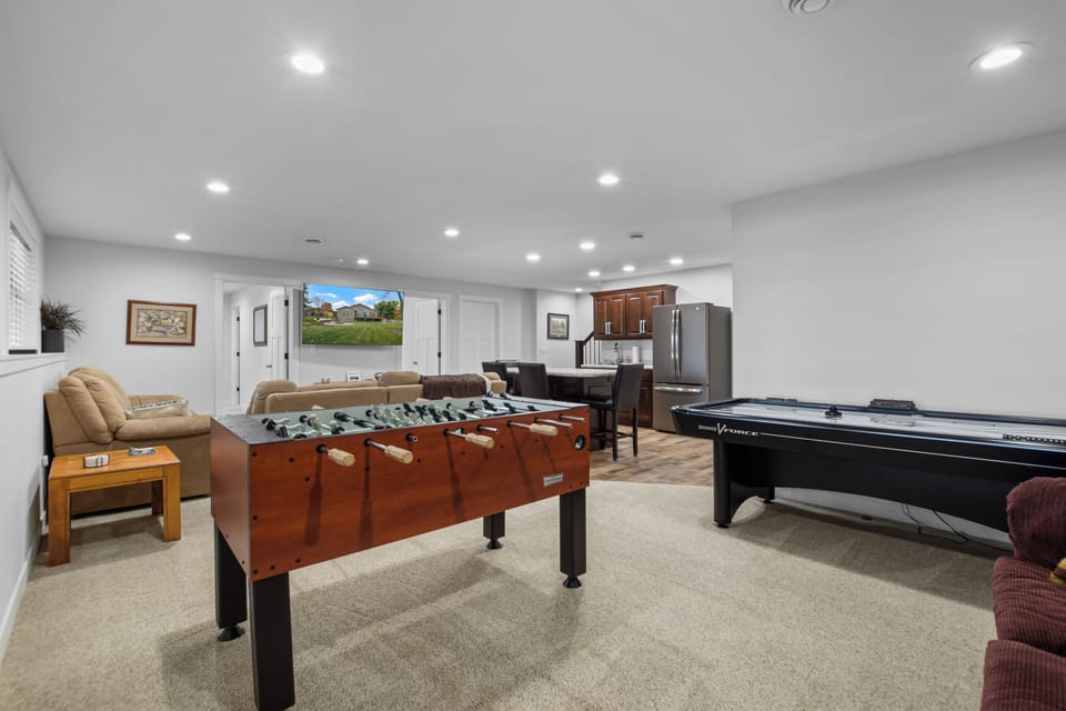 Lower level with game room, smart TV, and wet bar with ice maker
