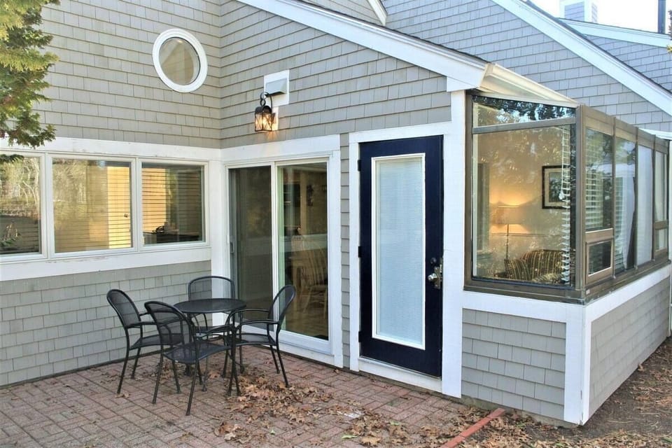 Tree-lined private back patio with view of the golf course