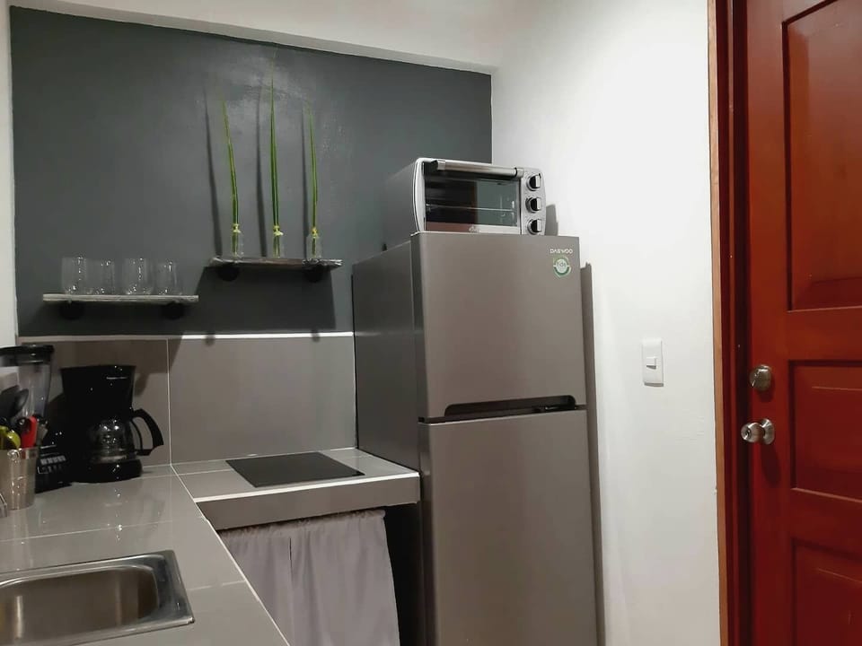 Kitchen with stove, electric small oven , coffee maker w/ coffee and tea, dishes etc