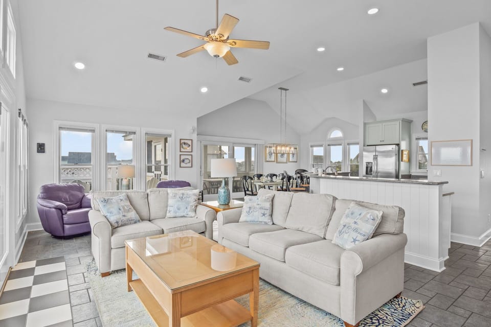 Picturesque views surround all of the top floor which encompasses the great room, kitchen, dining area, and a half bath.