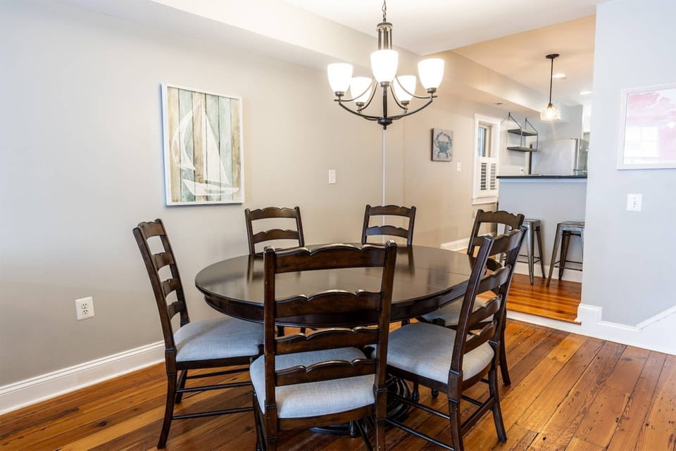 The dining room table seats six (with two more seats at the bar) and opens up to the living room.