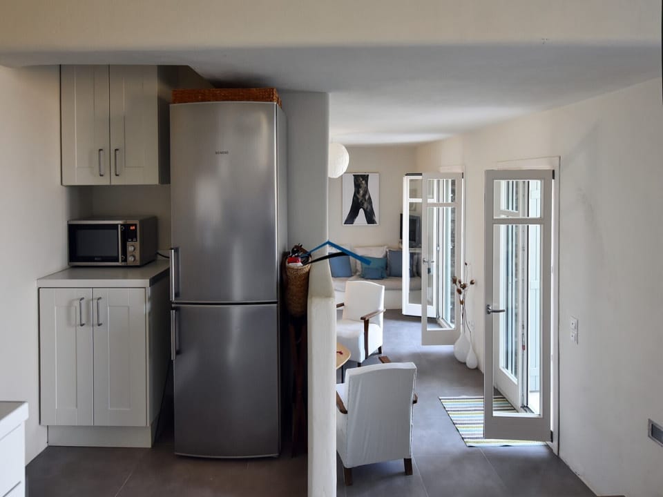 The kitchen and steps leading to the living room