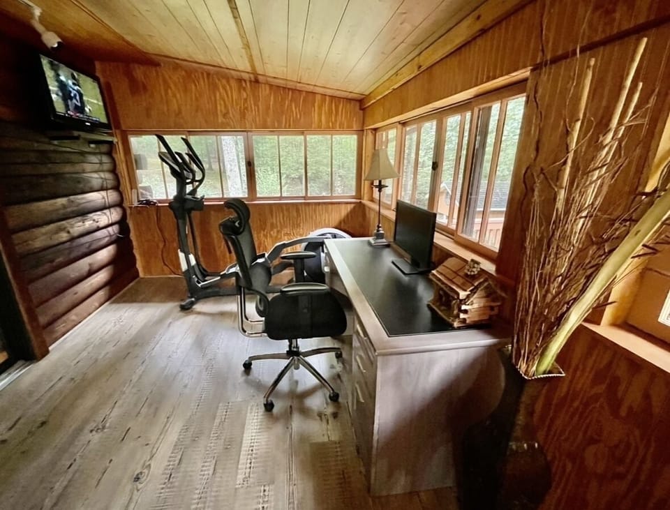 Office Space w/ Desk and Monitor and Fitness Space w/ Elliptical, Yoga Mat & TV