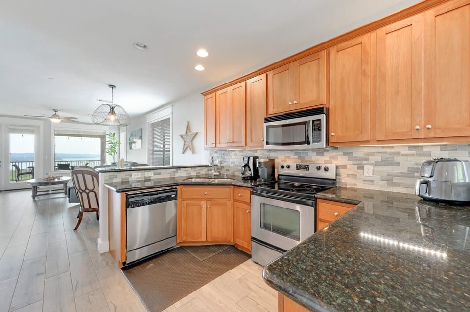 Kitchen with view toward dining/living/balcony