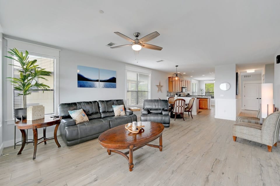 Living looking toward dining, kitchen, and bonus room at rear