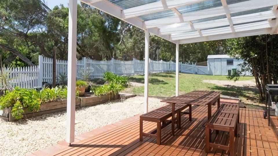 Outdoor patio with pergola, BBQ and 10 seat alfresco setting.