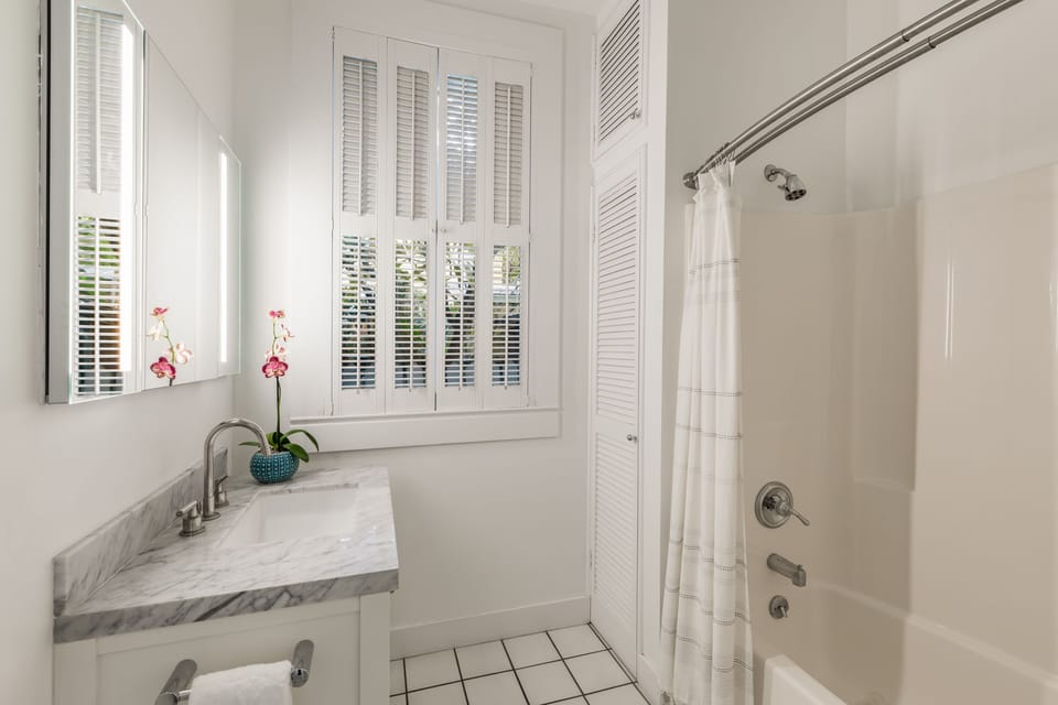 Main level bath right off the kitchen and outdoor living areas