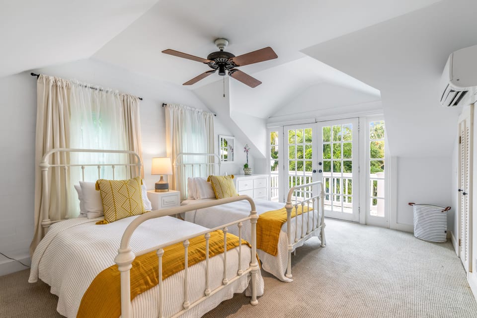 Kids room with two twin beds, TV, individual heating/cooling, and balcony