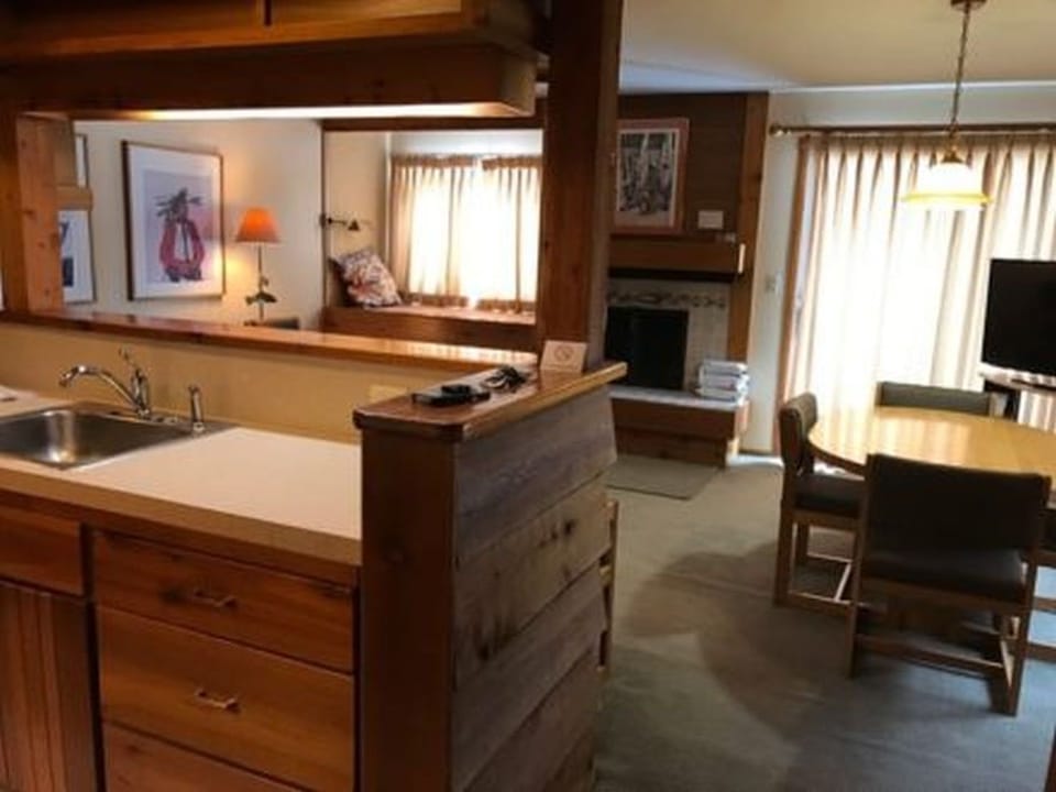 Kitchen, dining, and living room. Patio door and fireplace.